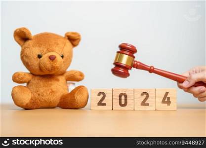 2024 year block with toy bear with gavel justice hammer. Children, Kid, Family Law and Happy New year concepts