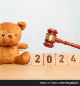 2024 year block with toy bear with gavel justice hammer. Children, Kid, Family Law and Happy New year concepts