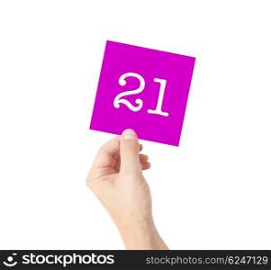 21 written on a card held by a hand