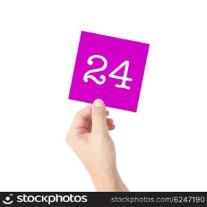 24 written on a card held by a hand