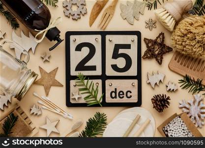 25 December made with Vintage Wood Calendar. Zero waste Christmas concept, eco friendly decorations, flat lay, top view on paper background