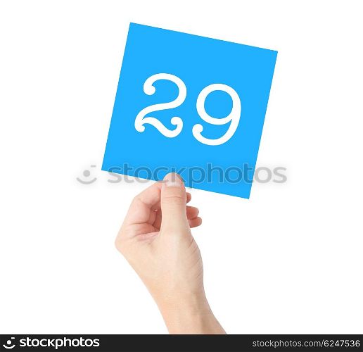29 written on a card held by a hand