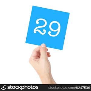 29 written on a card held by a hand