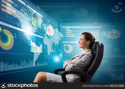 3 d technologies. Young businesswoman in chair near tv screen