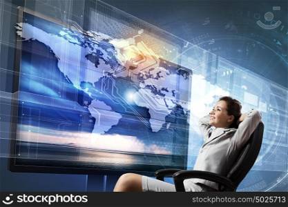 3 d technologies. Young businesswoman in chair near tv screen