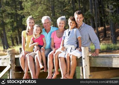 3 Generation family sitting by lake