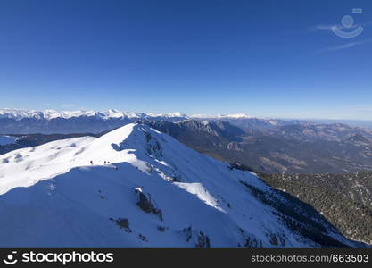 3 mountain climbers walk on snow in the mountains