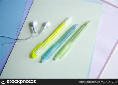 3 pens and a pair of earphones