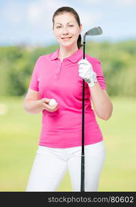 30-year-old girl with the equipment for the game of golf on a background of golf courses