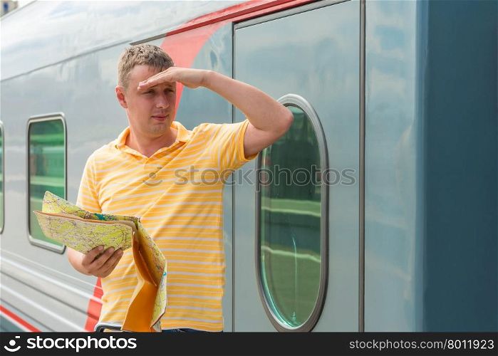 30-year-old man with a map in hand looking into the distance