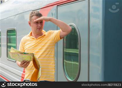 30-year-old man with a map in hand looking into the distance