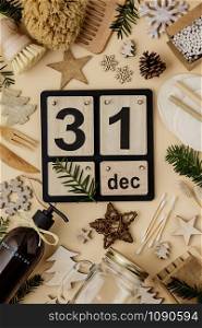 31 December made with Vintage Wood Calendar. Zero waste New year concept, eco friendly decorations, flat lay, top view on paper background