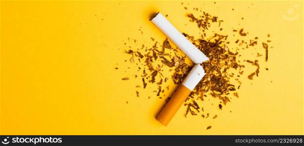 31 May of World No Tobacco Day, no smoking, close up of broken pile cigarette or tobacco STOP symbolic on yellow background with copy space, and Warning lung health concept