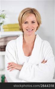 35-40 years old blonde woman dressed in bathrobe in her bathroom