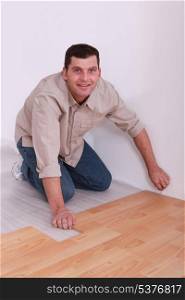 35 years old handyman laying parquet