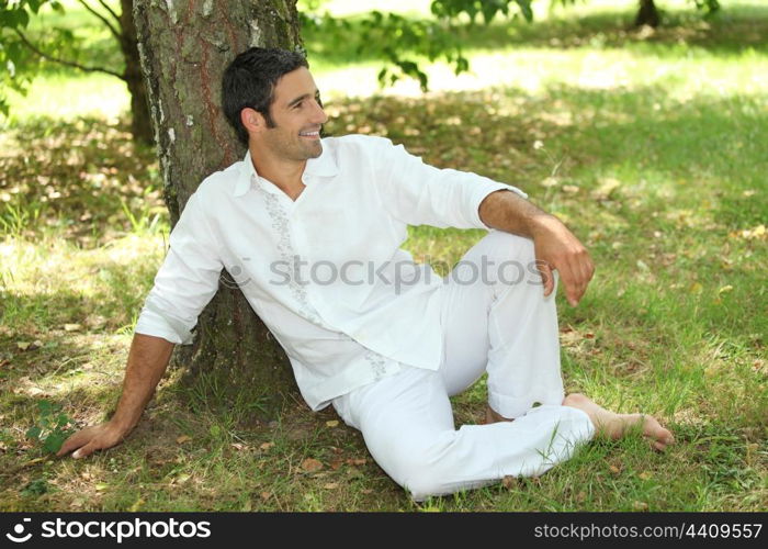 35 years old lying down under a tree