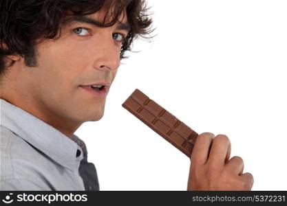 35 years old man eating a chocolate bar
