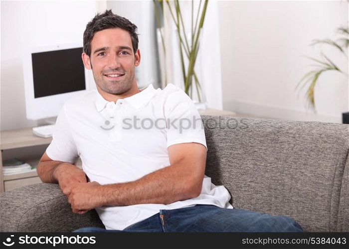 35 years old man sitting in a comfortable couch