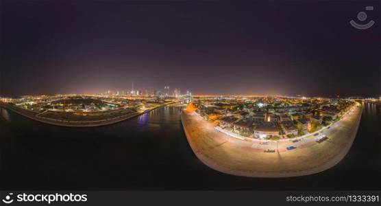 360 panorama by 180 degrees angle seamless panorama of aerial view of Dubai Downtown skyline and highway, United Arab Emirates or UAE. Financial district in urban city. Skyscraper buildings at night.