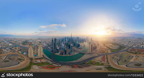 360 panorama by 180 degrees angle seamless panorama of aerial view of Dubai Downtown skyline and highway, United Arab Emirates or UAE. Financial district in urban city. Skyscraper buildings at sunset.