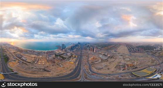 360 panorama by 180 degrees angle seamless panorama of aerial view of Dubai Downtown skyline and highway, United Arab Emirates or UAE. Financial district in urban city. Skyscraper buildings at sunset.