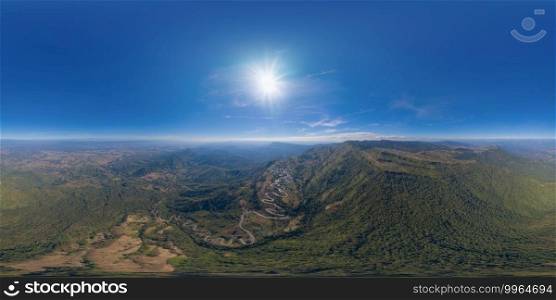 360 panorama by 180 degrees angle seamless panorama of aerial view of cars driving on curved, zigzag curve road or street on mountain hill with green natural forest trees in rural area of Phu Tub Berk