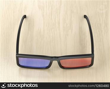 3D glasses on wood background