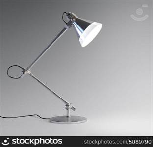 3D image of metal desk lamp isolated on dark background