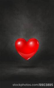 3D red heart isolated on a black studio background. 3D illustration. 3D red heart on a black studio background