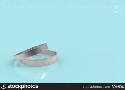 3d rendering. a pair of simple wedding rings on light blue background.