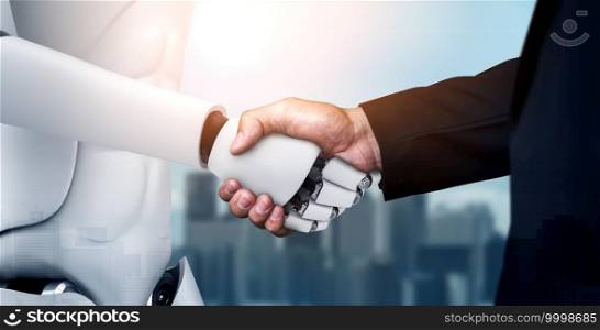 3D rendering humanoid robot handshake to collaborate future technology development by AI thinking brain, artificial intelligence and machine learning process for 4th industrial revolution.. 3D rendering humanoid robot handshake to collaborate future technology
