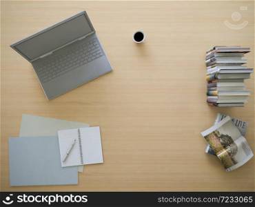 3d rendering of working table with depth of field photo. working wooden table which have laptop, book,notebook,coffee cup on it, business concept. Top view and flatlay photo style