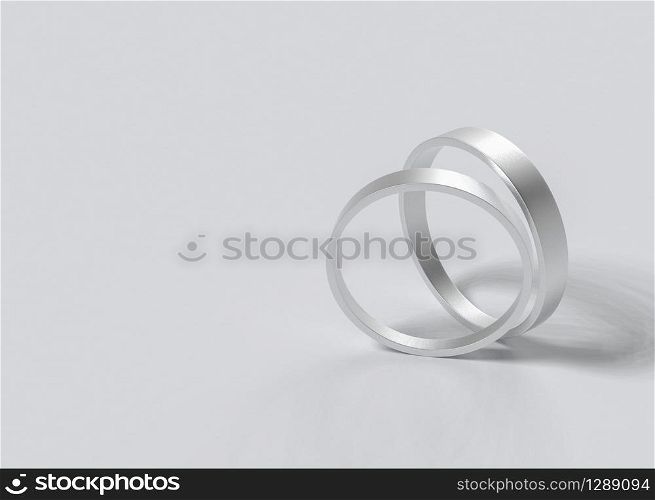 3d rendering. Pair of simple wedding rings on Gray background.