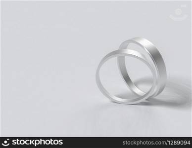 3d rendering. Pair of simple wedding rings on Gray background.