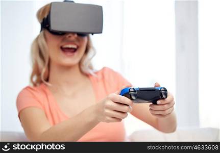 3d technology, augmented reality, gaming, entertainment and people concept - happy young woman with virtual reality headset or 3d glasses playing video game with controller gamepad at home
