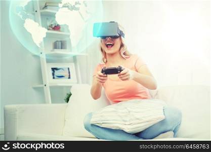 3d technology, augmented reality, gaming, entertainment and people concept - woman in virtual headset or 3d glasses playing video game with controller gamepad at home looking projection of earth globe. woman in virtual reality headset with controller