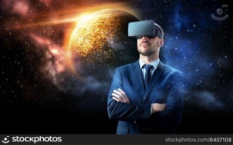 3d technology, virtual reality, cyberspace and augmented reality concept - young businessman with virtual reality headset or 3d glasses over planet and space background. businessman in virtual reality headset over space