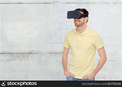 3d technology, virtual reality, entertainment and people concept - happy young man with virtual reality headset or 3d glasses over concrete gray wall background