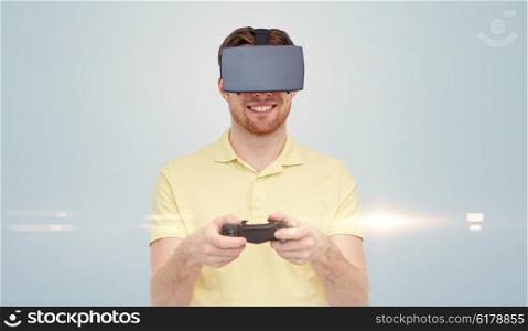 3d technology, virtual reality, entertainment and people concept - happy young man with virtual reality headset or 3d glasses playing with game controller gamepad over gray background