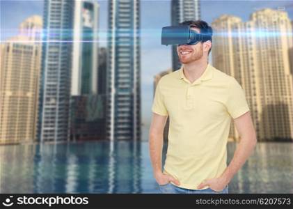 3d technology, virtual reality, entertainment and people concept - happy young man with virtual reality headset or 3d glasses over dubai city infinity edge pool background