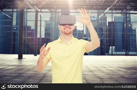 3d technology, virtual reality, entertainment and people concept - happy young man with virtual reality headset or 3d glasses playing game over industrial empty room and city panorama background. happy man in virtual reality headset or 3d glasses