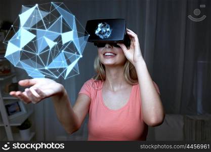 3d technology, virtual reality, entertainment and people concept - happy young woman with virtual reality headset or 3d glasses playing with low poly shape projection over black background