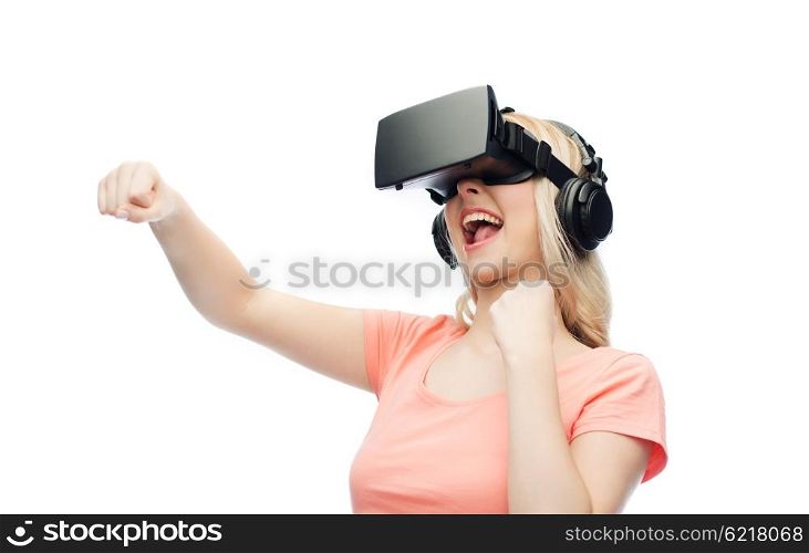 3d technology, virtual reality, entertainment and people concept - happy young woman with virtual reality headset or 3d glasses playing game and fighting