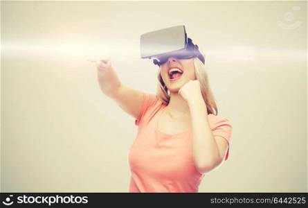3d technology, virtual reality, entertainment and people concept - happy young woman with virtual reality headset or 3d glasses playing game and fighting over gray background and laser light. woman in virtual reality headset or 3d glasses