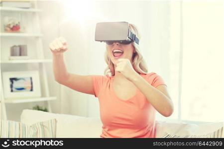 3d technology, virtual reality, entertainment and people concept - happy young woman with virtual reality headset or 3d glasses playing game and fighting at home. woman in virtual reality headset or 3d glasses