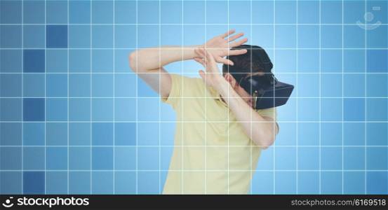 3d technology, virtual reality, entertainment and people concept - scared young man with virtual reality headset or 3d glasses playing game and covering from something over blue grid background