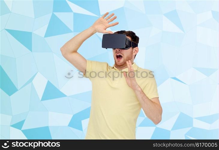 3d technology, virtual reality, entertainment and people concept - scared young man with virtual reality headset or 3d glasses playing game over low poly background