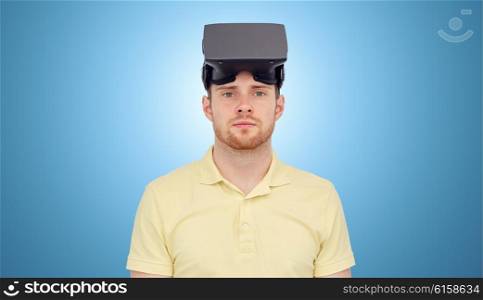 3d technology, virtual reality, entertainment and people concept - young man with virtual reality headset or 3d glasses over blue background