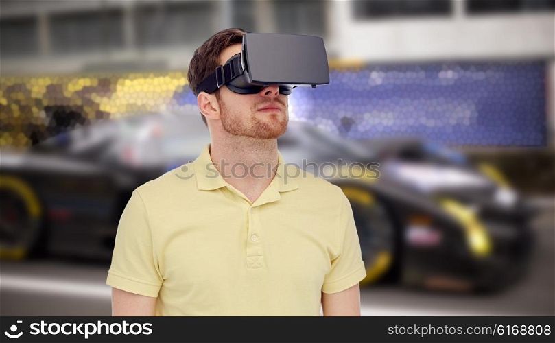 3d technology, virtual reality, entertainment and people concept - young man with virtual reality headset or 3d glasses playing car racing game over street race background