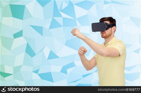 3d technology, virtual reality, entertainment and people concept - young man with virtual reality headset or 3d glasses playing game and fighting over low poly background